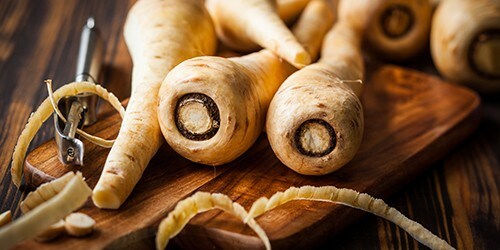 Fresh parsnip on wooden table
