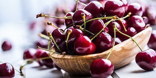 Cherries. Sweet Cherries. Fresh Cherries. Ripe cherries on wooden concrete table - board.