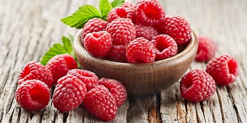 Raspberry on wooden board