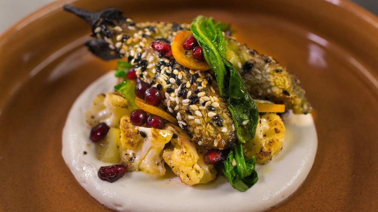 Sesame crusted aubergine, cauliflower puree, sautéed pak choi and kumquat