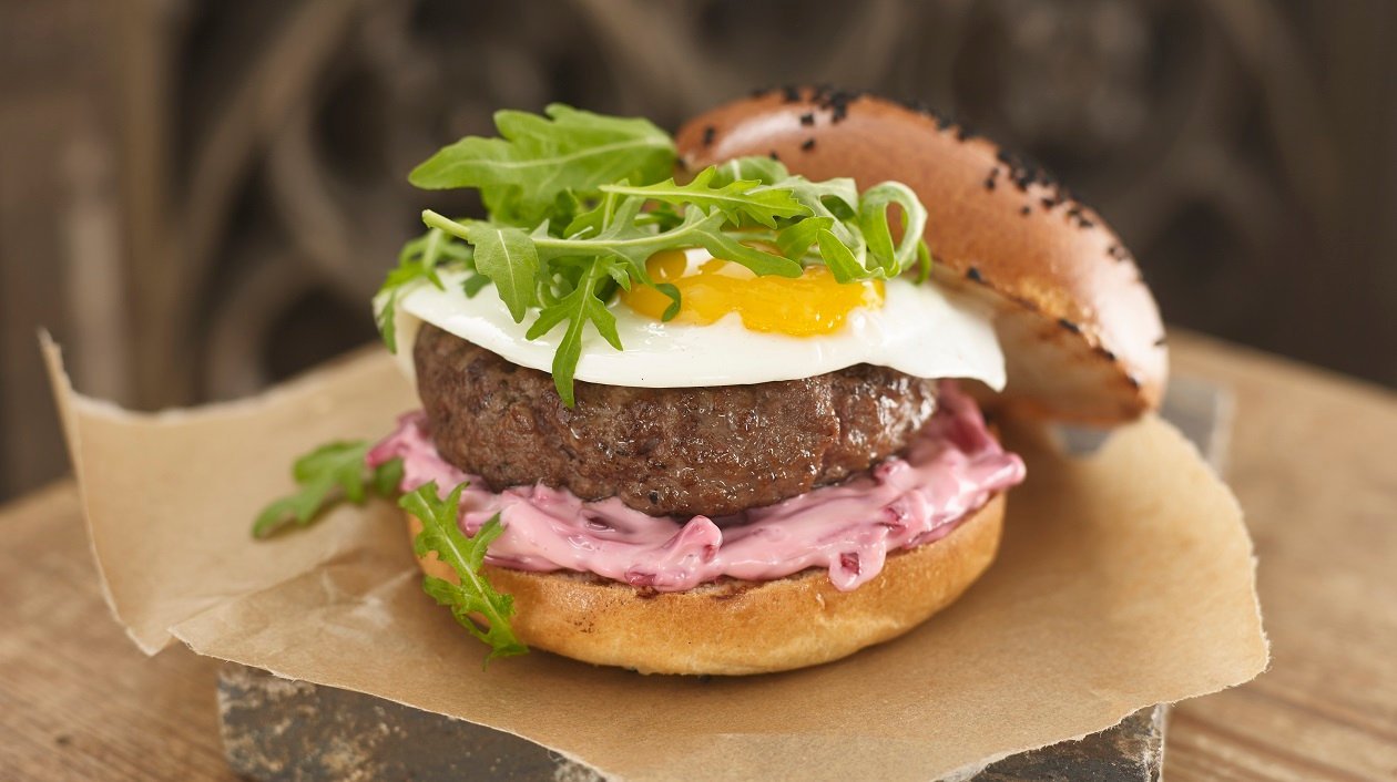 Australian burger with fried egg, beetroot and rocket