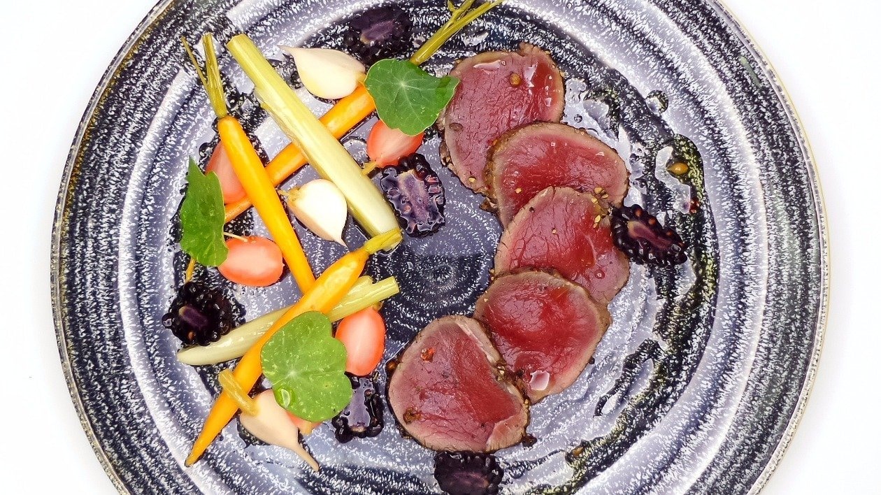 Cured venison with pickled garden vegetables, blackberries and nasturtium leaves