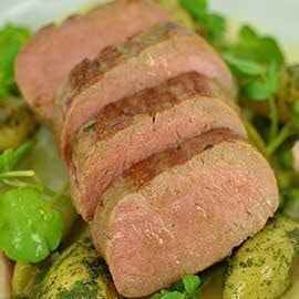Roast lamb loin with peas, chicory & bacon
