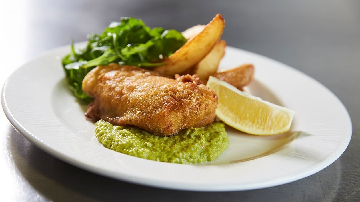 Spiced fish and chips with yoghurt pea puree