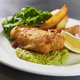 Spiced fish and chips with yoghurt pea puree Spiced fish and chips with yoghurt pea puree